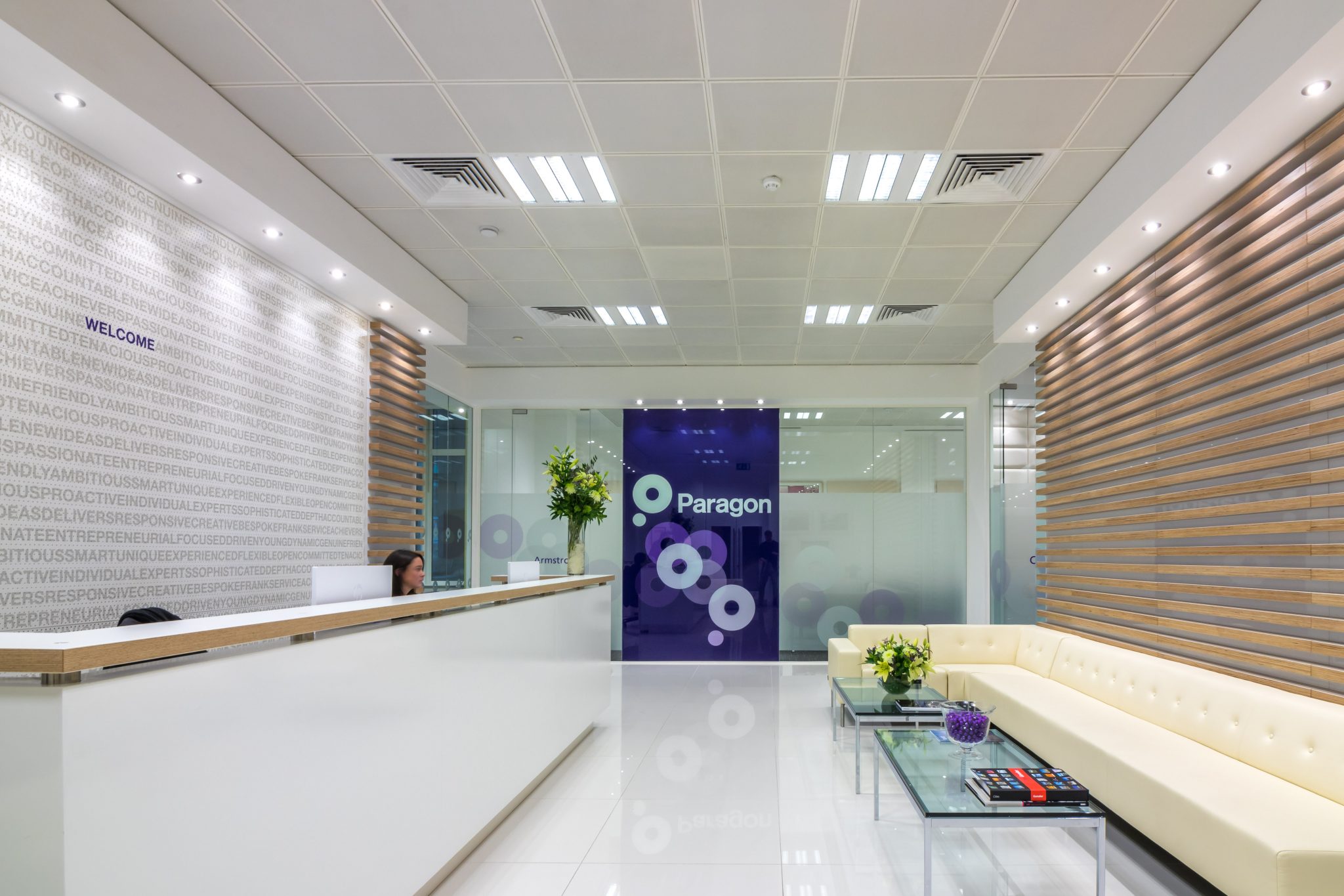 Reception with slatted timber wall and white furniture in a City of London office